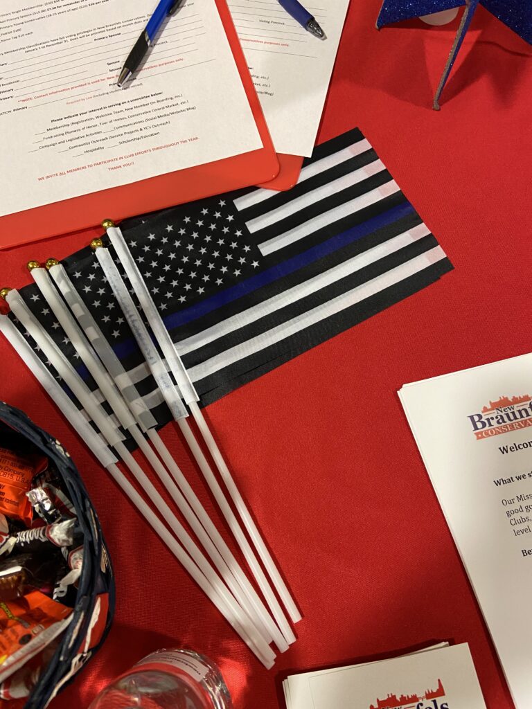 A table with several flags and papers on it.