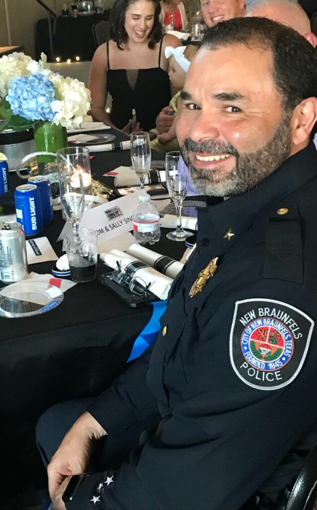 A man in police uniform sitting at a table.