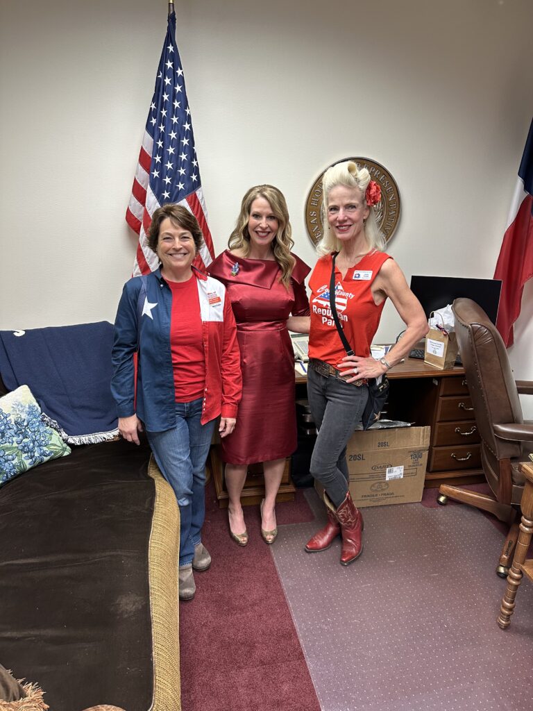 Three women in red and blue outfits posing for a picture.